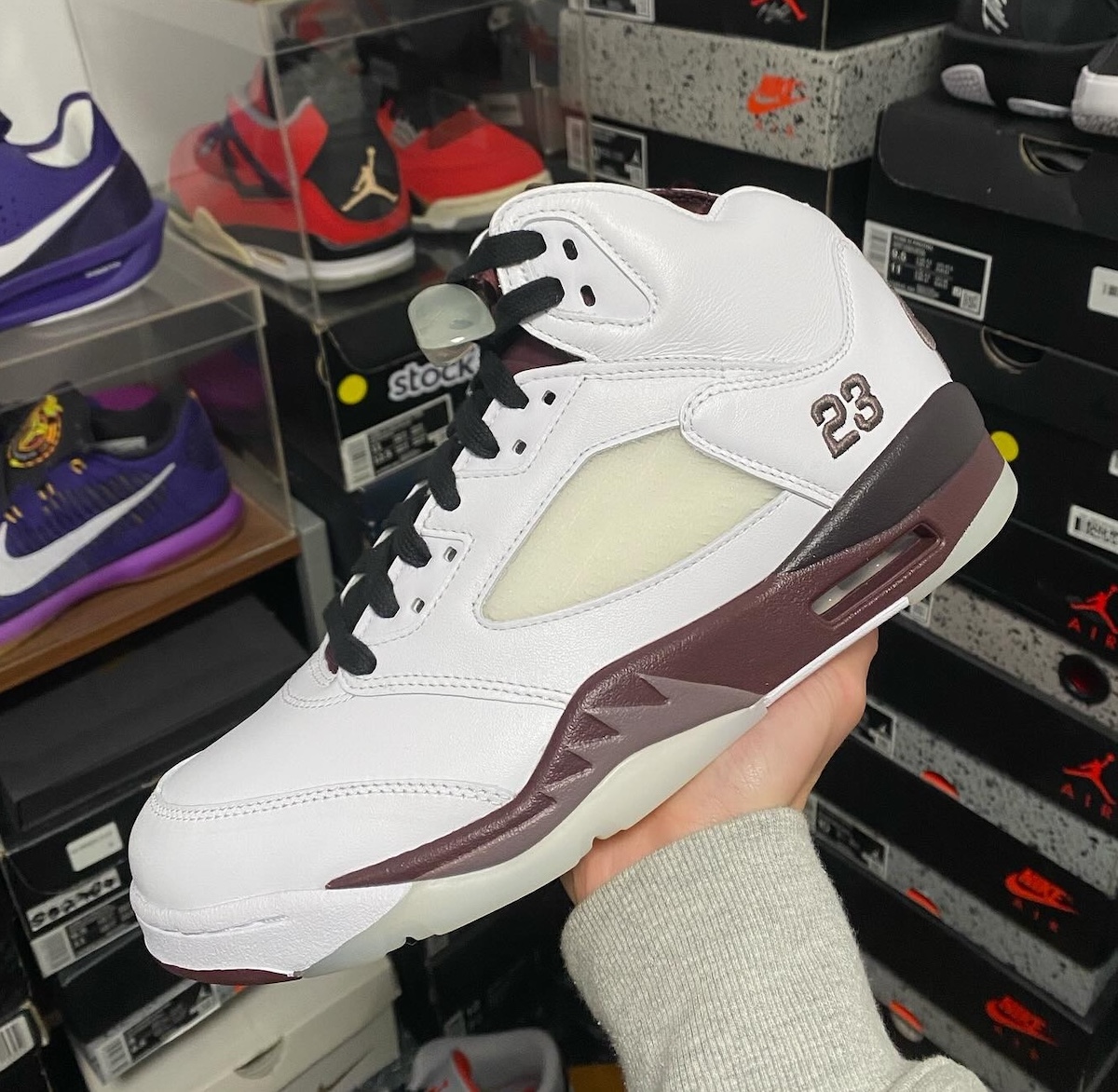 Side profile of the A Ma Maniere x Air Jordan 5 showing premium leather and burgundy accents.
