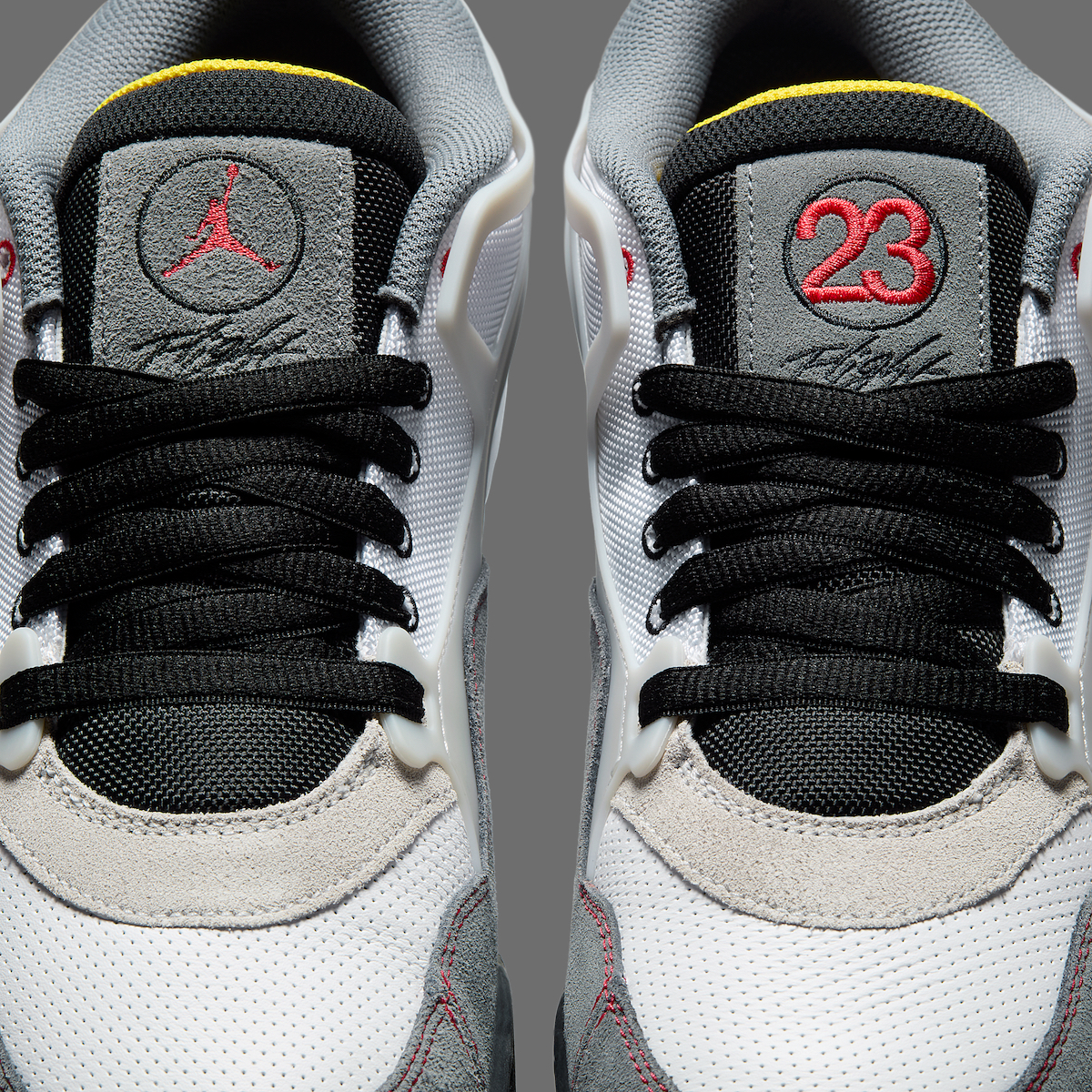 Close-up of Air Jordan 4 RM Motorsports tongue with Jumpman logo, Speed Yellow liner, and “23” embroidery.