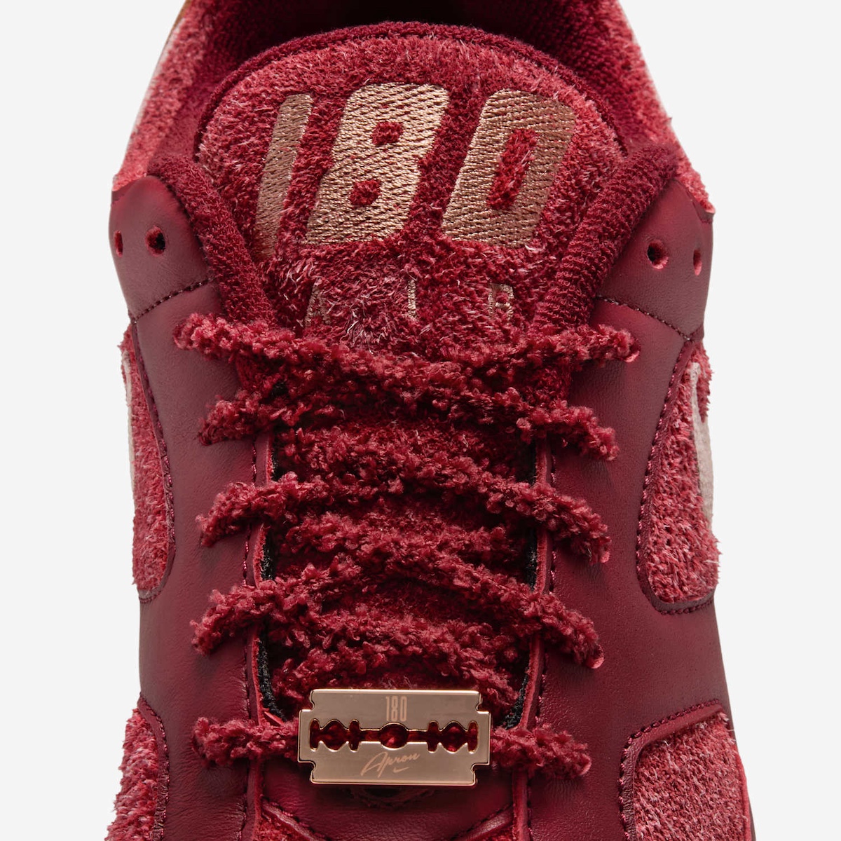 Close-up of fuzzy laces and razor blade dubrae on Apron Records x Nike Air 180 Bloodline