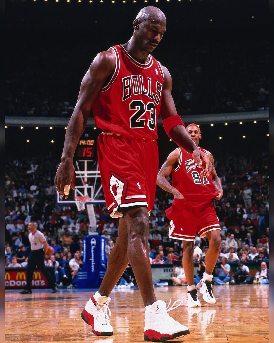 Michael Jordan wearing the OG Air Jordan 13 White True Red colorway during a Chicago Bulls away NBA game.