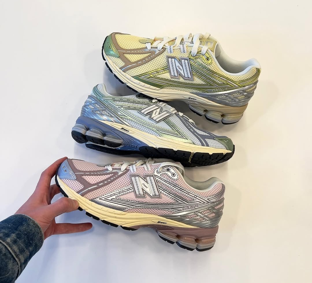 New Balance 1906R Pastel Pack featuring three pastel-themed sneakers stacked on top of each other, showcasing pink, blue, and yellow colorways.
