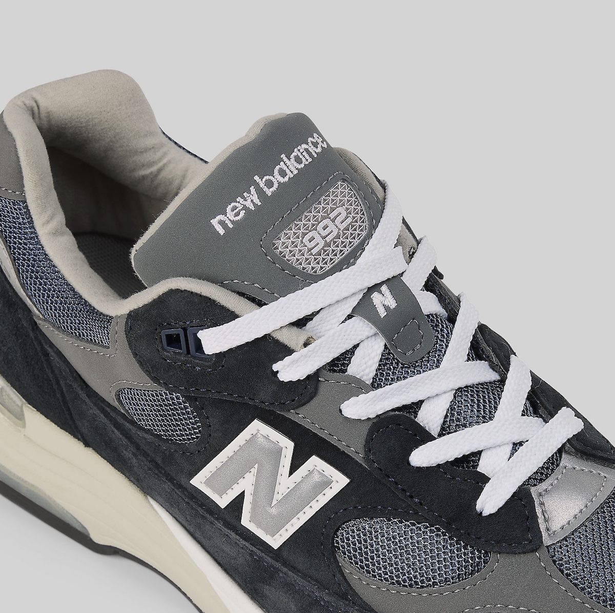 New Balance 992 Navy sneaker featuring navy suede and grey leather overlays.