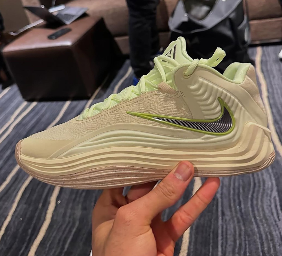 Nike Zoom Freak 7 in hand showcasing cream and lime green upper