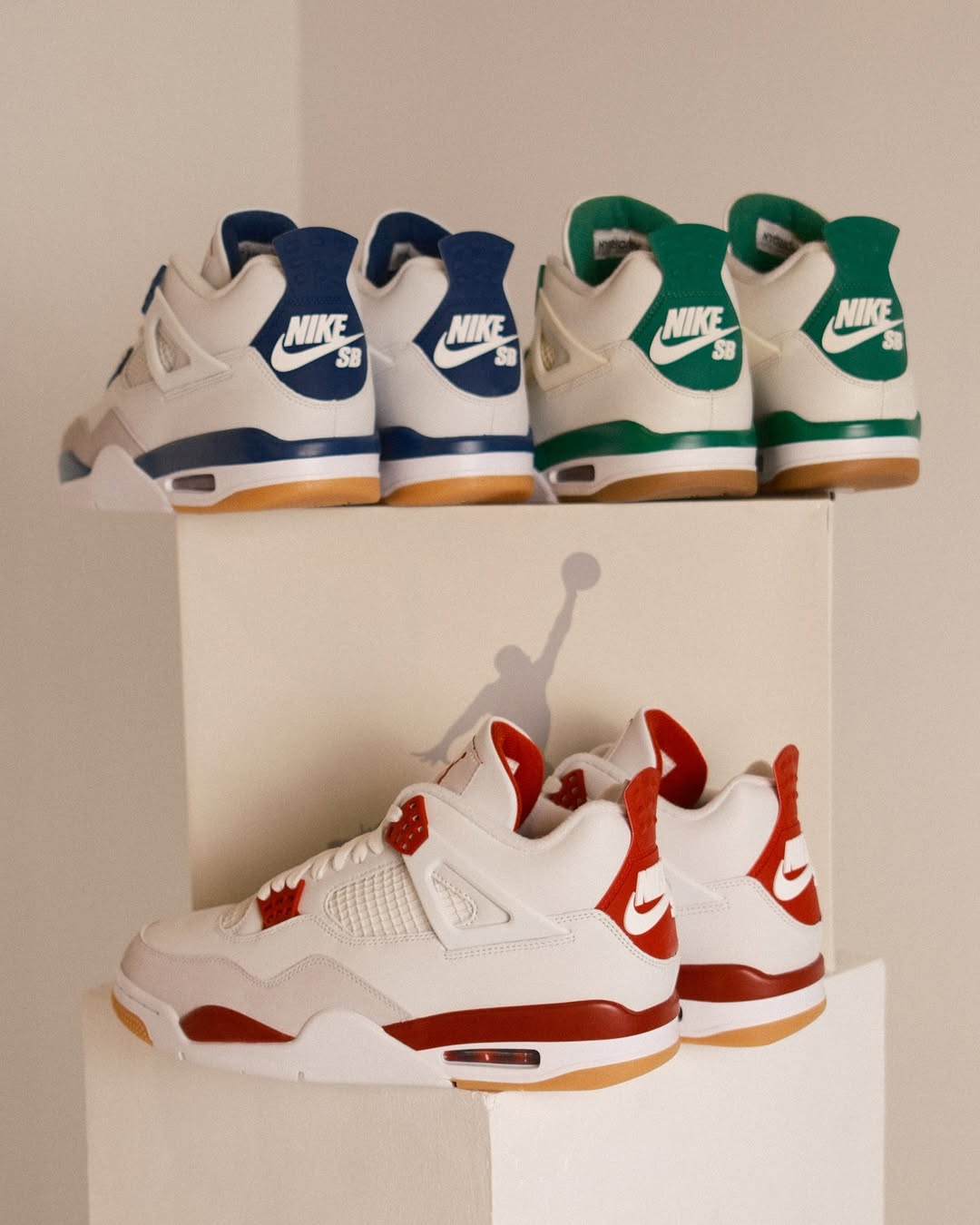 Nike SB Air Jordan 4 "Pine Green," "Navy," and "Red" pairs showcased together.