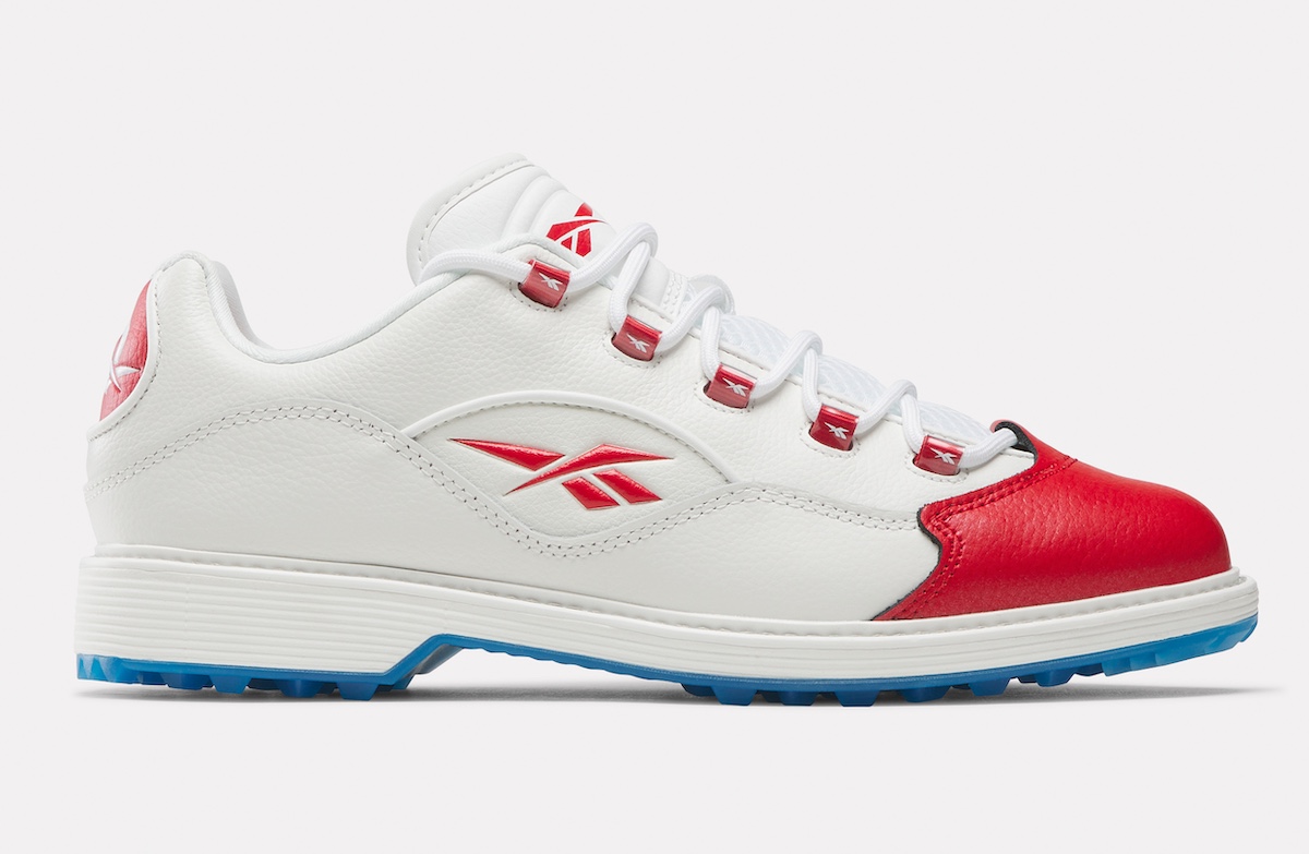 A lateral view of the Reebok Question Golf "Red Toe," showcasing the Reebok logo and premium leather detailing.