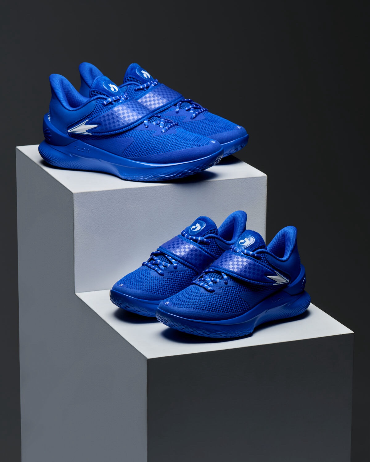 Mens and kids pairs of the Curry Fox 1 Lexington displayed on a pedestal