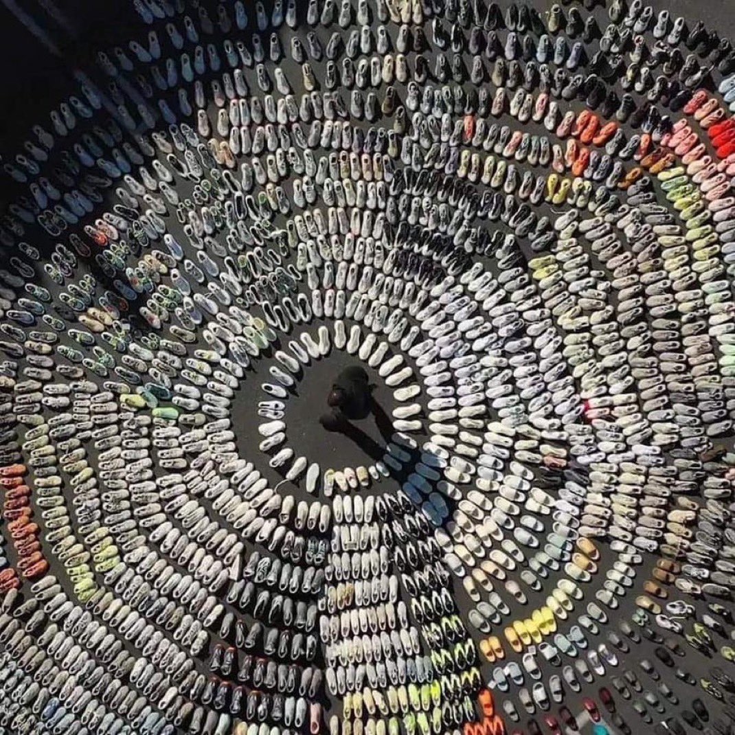 A massive collection of Yeezy sneakers arranged in a circular pattern.