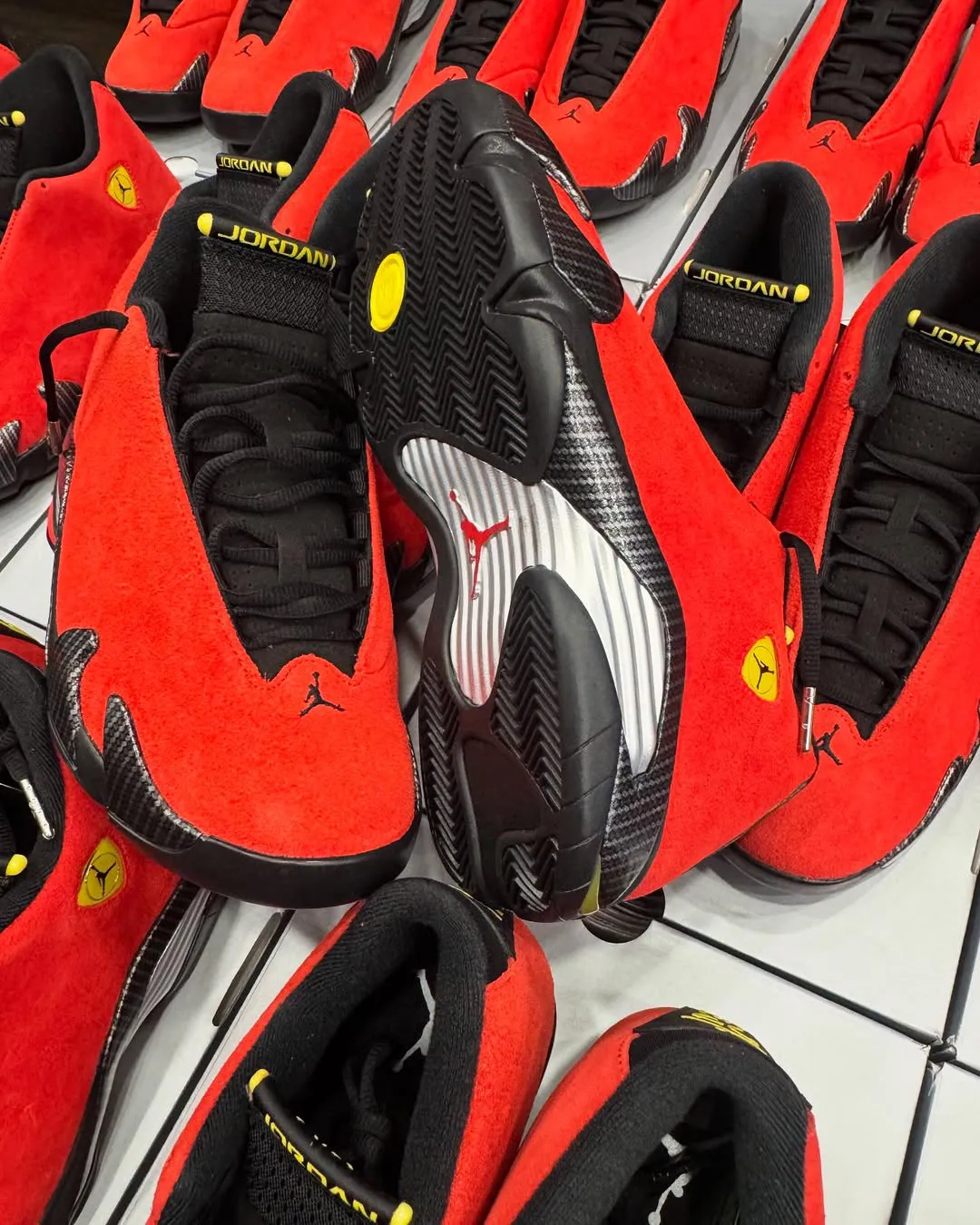 Underside of Air Jordan 14 Ferrari 2025 showcasing carbon fiber detailing and red Jumpman logo.