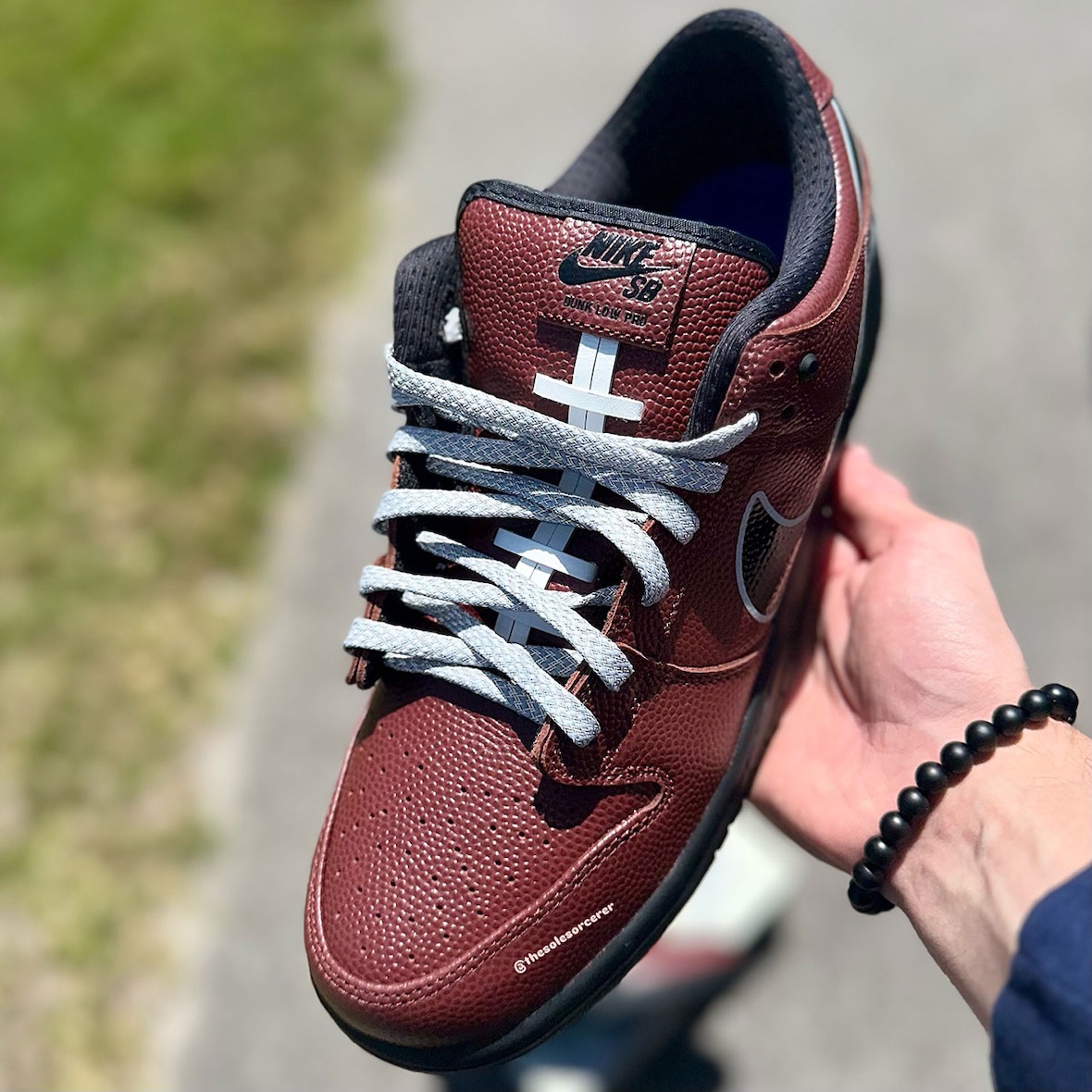 Nike SB Dunk Low Limosine Skateboards in Football Brown with gray laces, showing tongue details and textured leather upper.