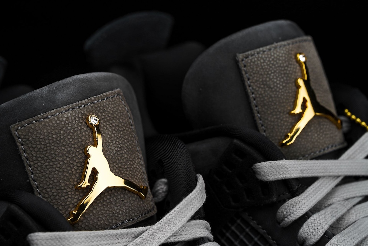 Close-up of San Diego State University Air Jordan 4 PE 2025 featuring a gold Jumpman logo with diamond detail on black suede tongue.