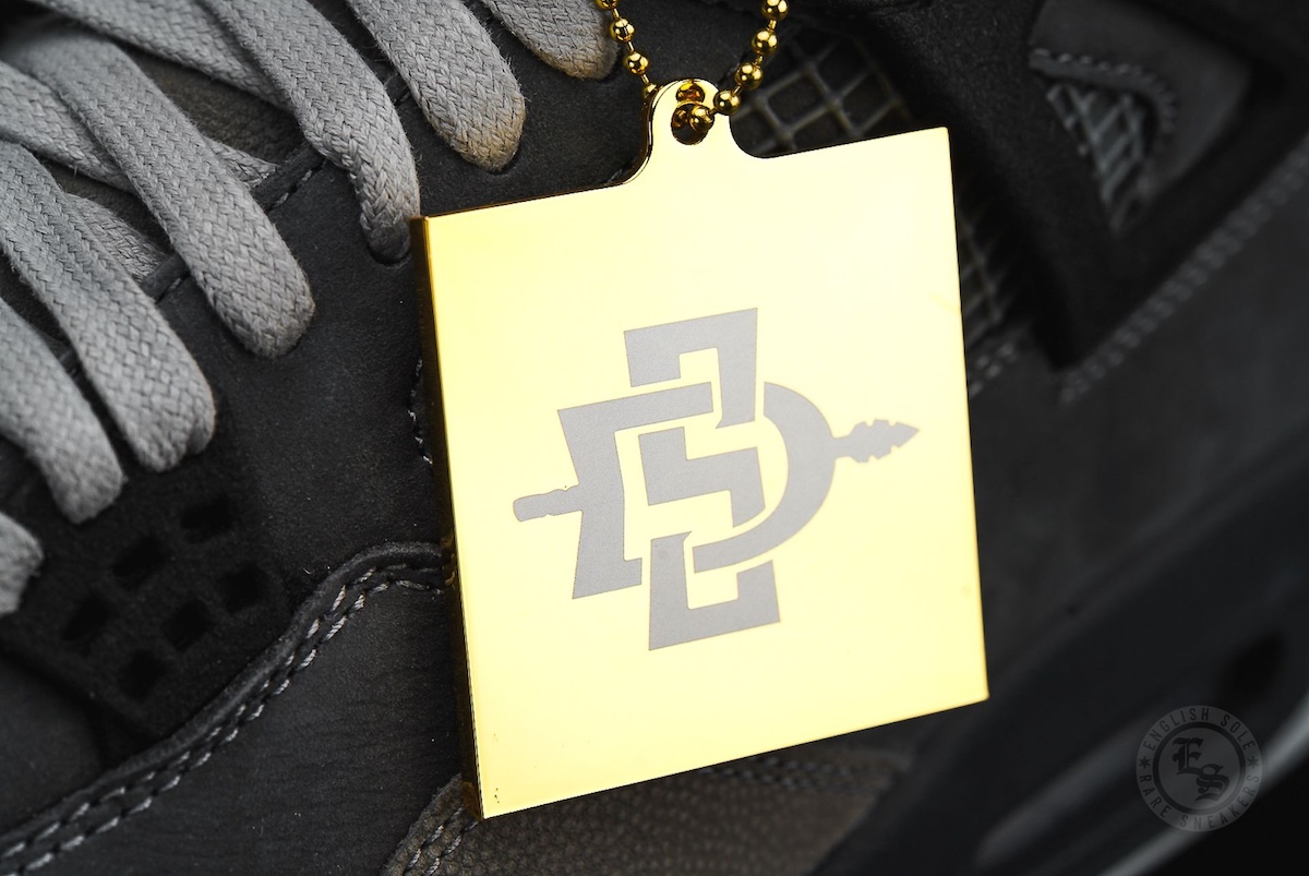 Gold hangtag featuring the San Diego State University Aztecs logo attached to the limited-edition Air Jordan 4 PE 2025 sneaker.
