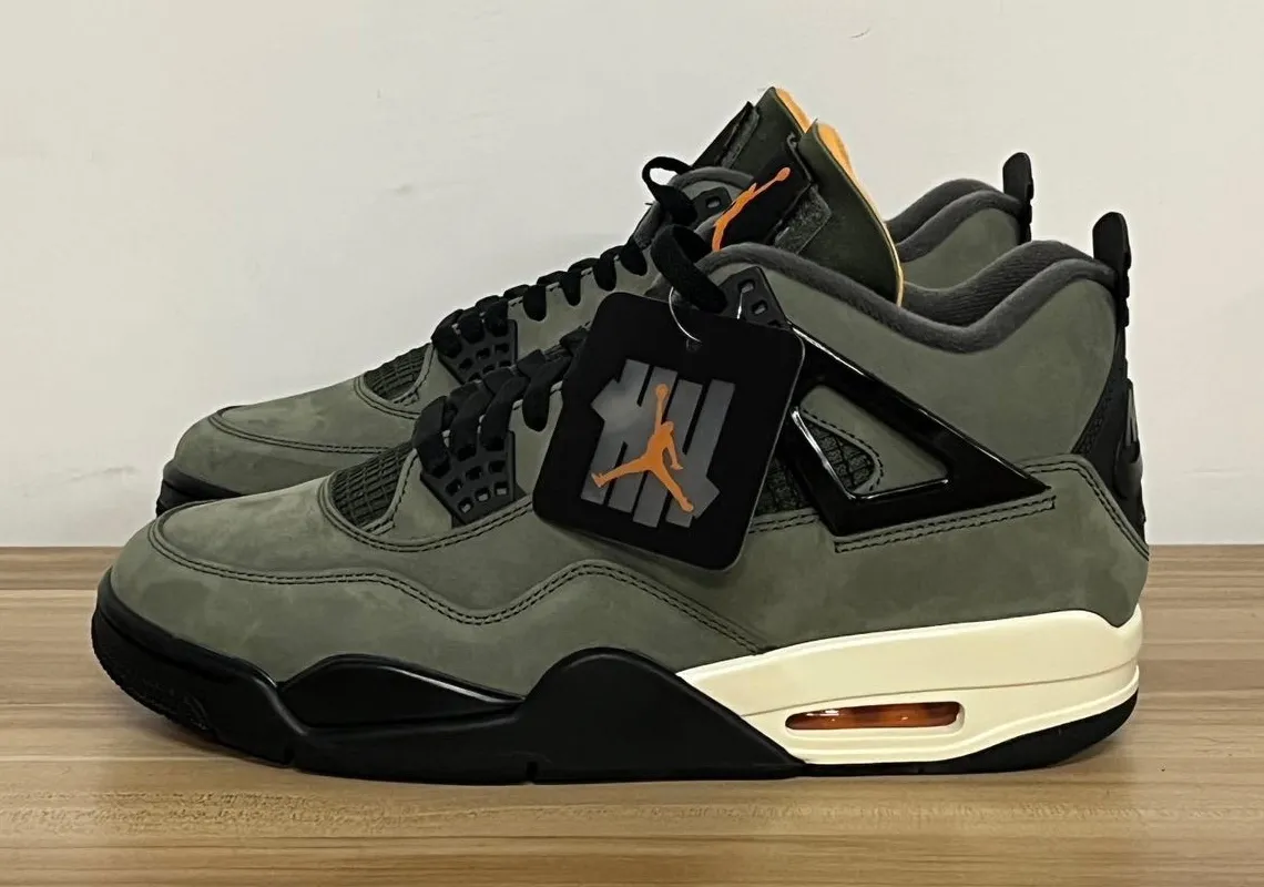 Side view of the Undefeated Air Jordan 4 in Deep Green with hangtag, releasing June 2025