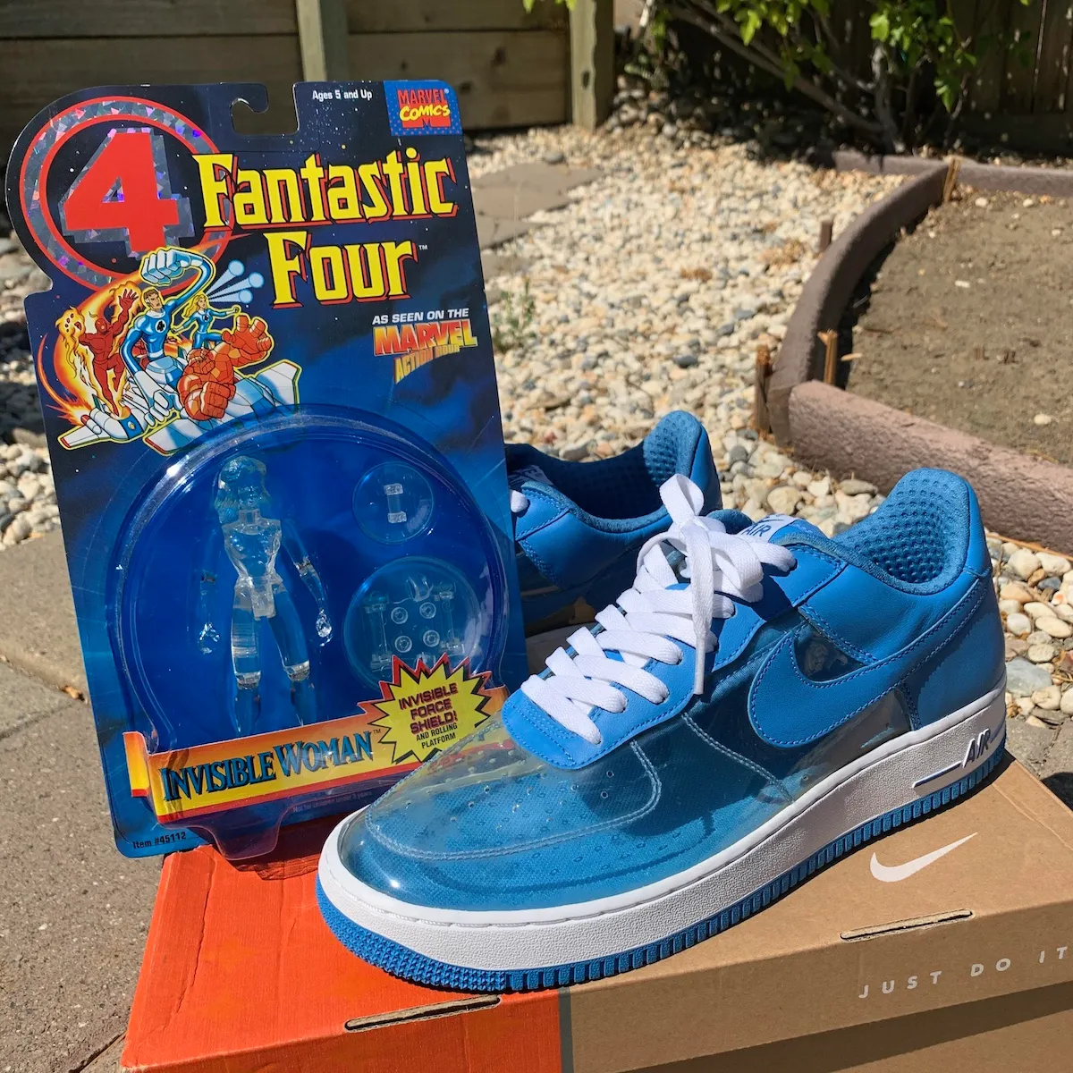 2006 Nike Air Force 1 Low Invisible Woman sneaker in blue with translucent panels next to a Marvel Fantastic Four Invisible Woman action figure.