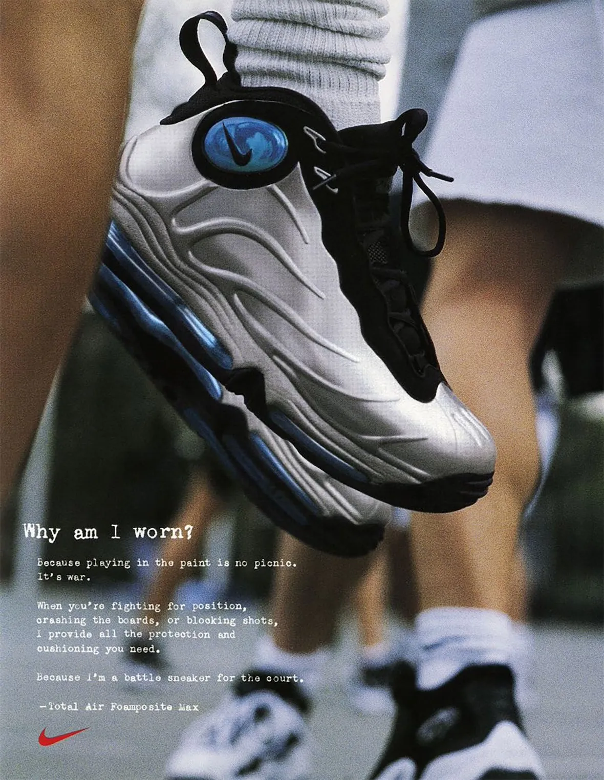 Close-up of the original Nike Total Air Foamposite Max in silver and blue during an outdoor basketball run.