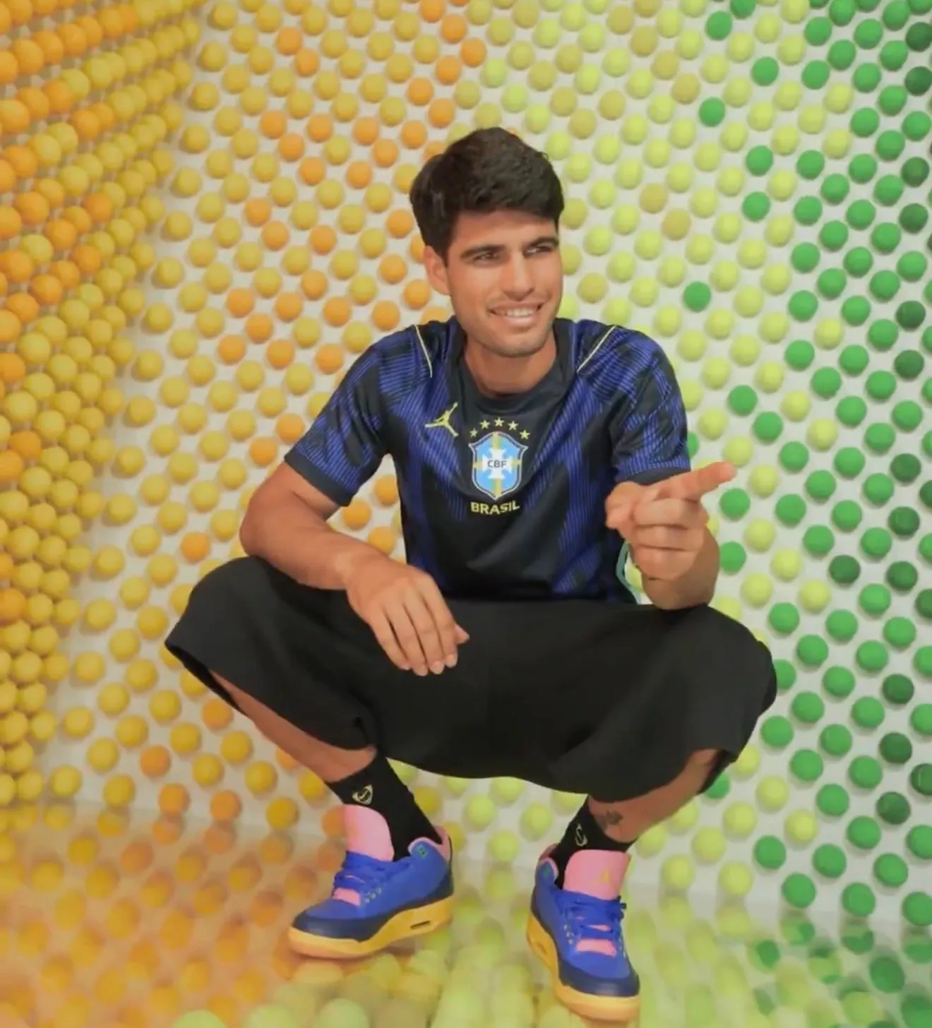 On-foot look at the Air Jordan 3 Brazil worn with a Brazil jersey in a colorful photo shoot