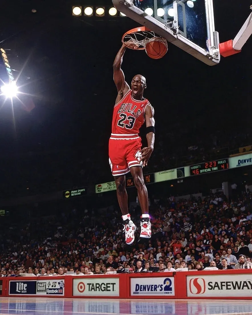 Michael Jordan dunking in the Air Jordan 6 Carmine