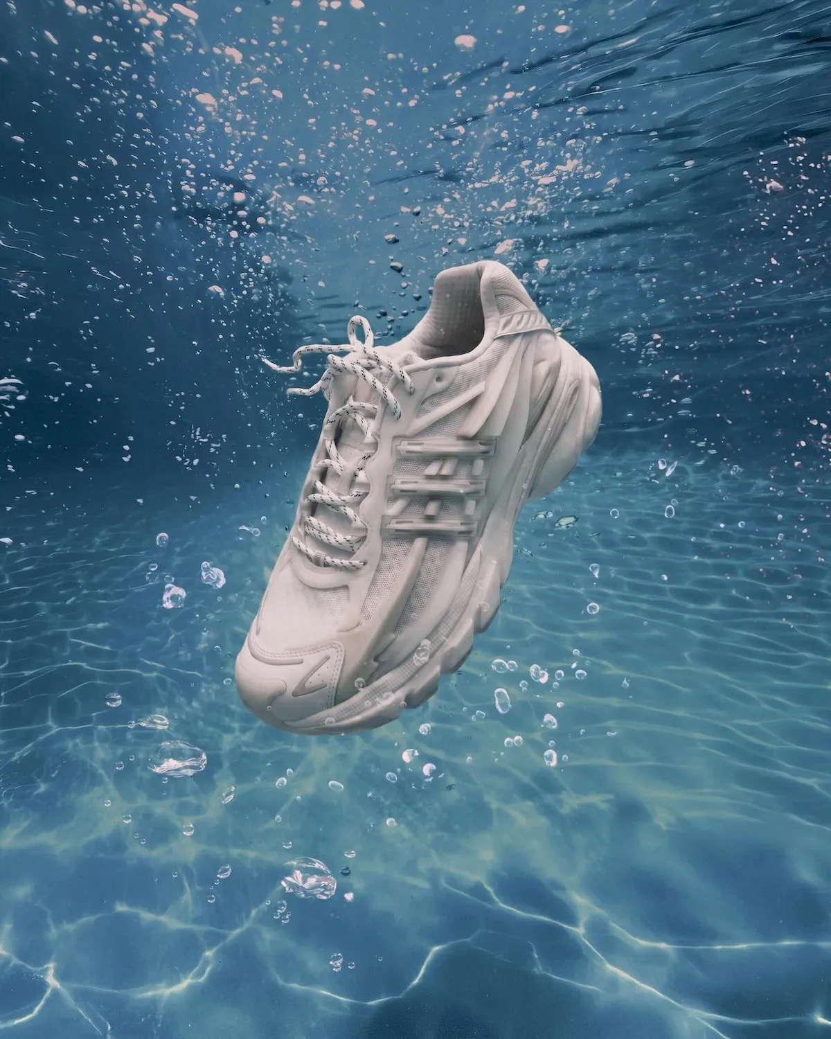 Pharrell x adidas Adistar Jellyfish Triple White featuring all-white mesh upper, molded cage overlay, and curved midsole - detail view 2