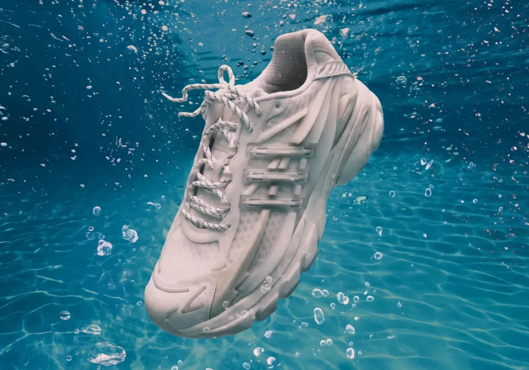 Pharrell x adidas Adistar Jellyfish Triple White featuring all-white mesh upper, molded cage overlay, and curved midsole - detail view 1