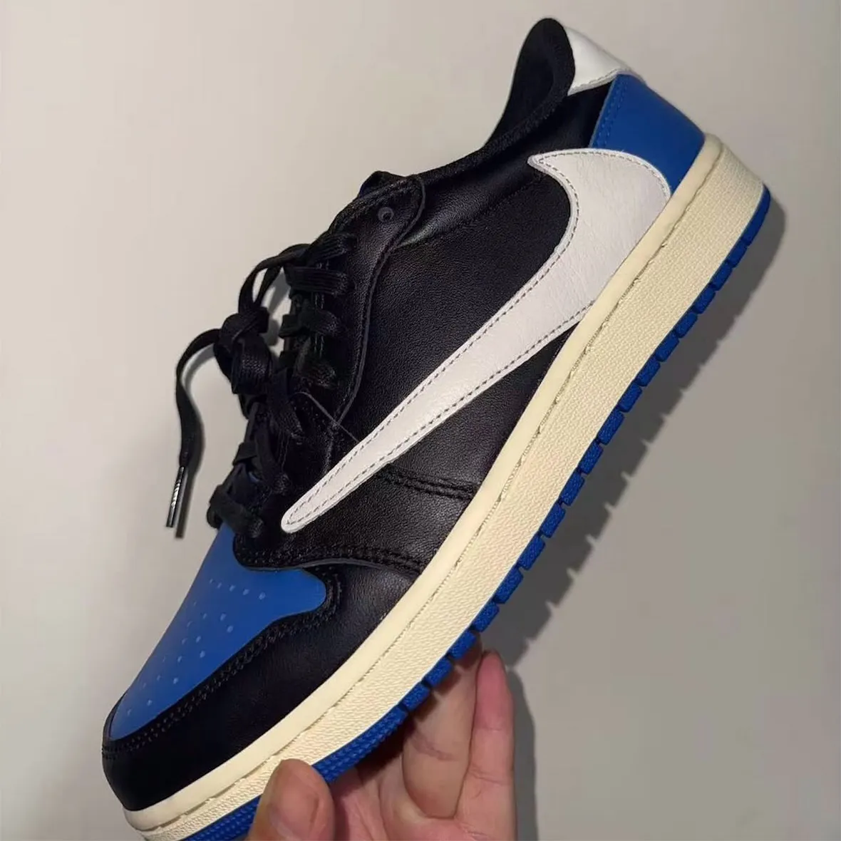 Travis Scott x Fragment x Air Jordan 1 Low sample in black leather with royal blue accents on toe box and Swoosh - detail view 3