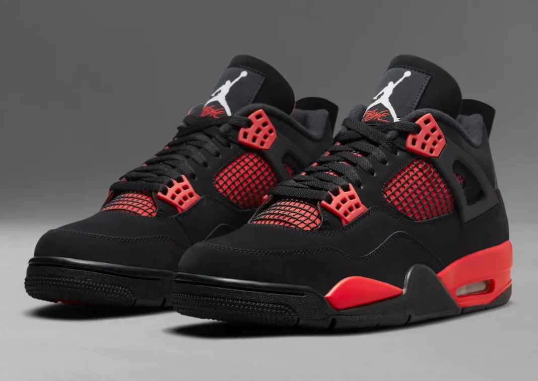 Air Jordan 4 'Red Thunder' with black nubuck upper and crimson accents on side mesh and midsole - detail view 1