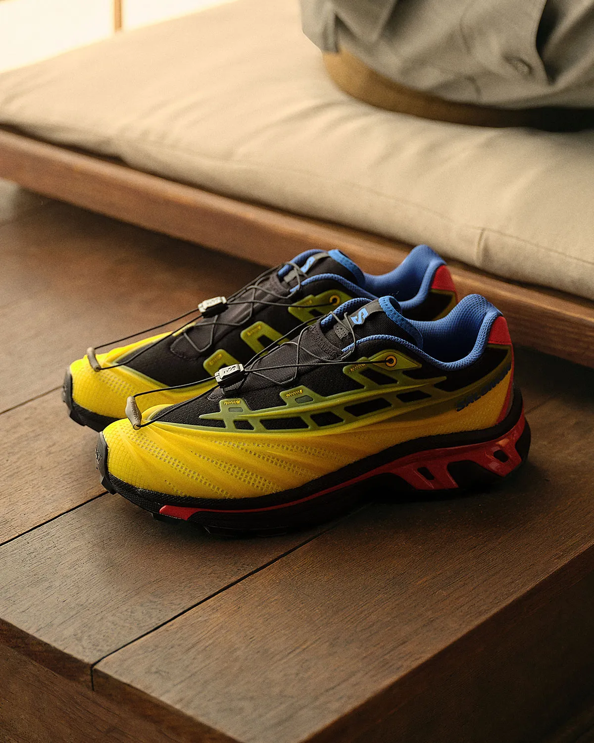 Kith x Salomon XT-EVO in black, yellow, red and blue colorway, featuring molded TPE upper and reinforced trail-running sole - detail view 2