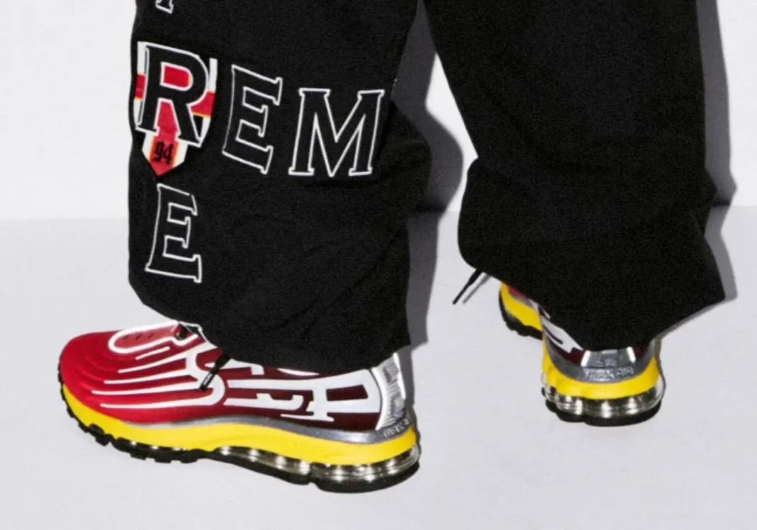Supreme x Nike Air Max 2000 in University Red and Speed Yellow, showing the Supreme lettering branding on the lateral side - detail view 1